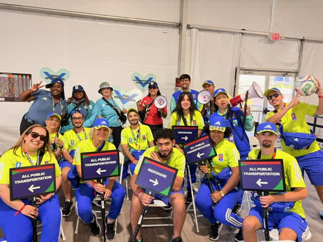 A large event team celebrates shared work and contribution.